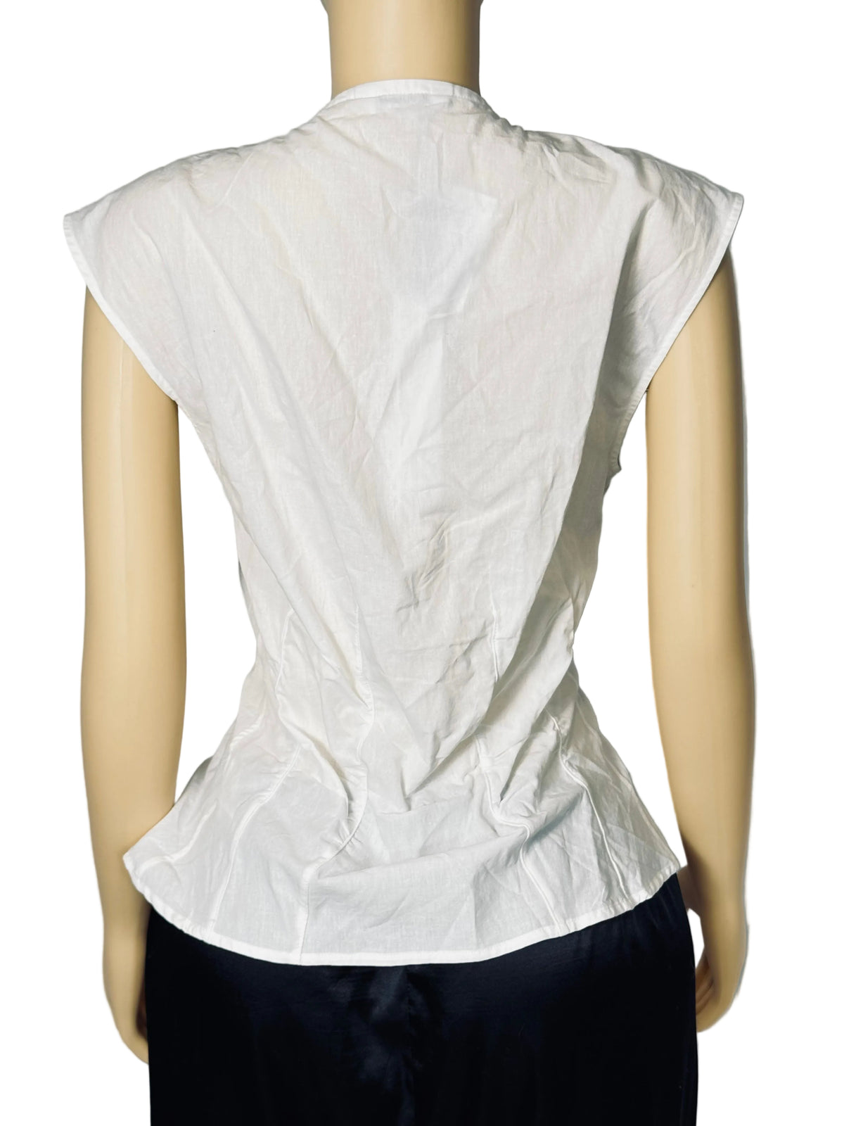 White sleeveless peplum top shown from the back on a mannequin, paired with dark bottoms, against a light gray backdrop.