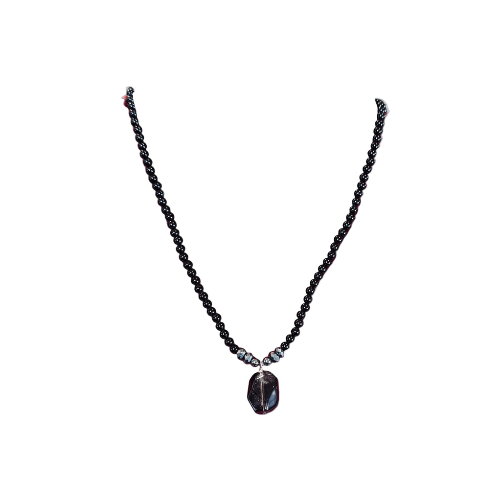 Black beaded Necklace with a Smokey quartz pendant on a white background
